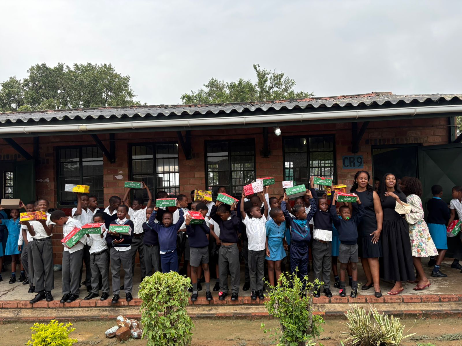 Learners celebrating the donated shoes at Manzolwandle Primary School